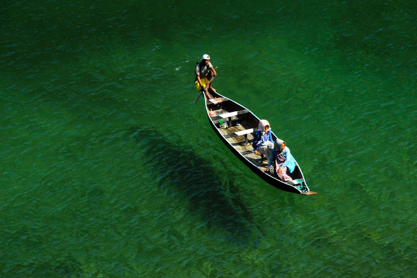 A boat on the clear green Umngot river at Dawki, Meghalaya