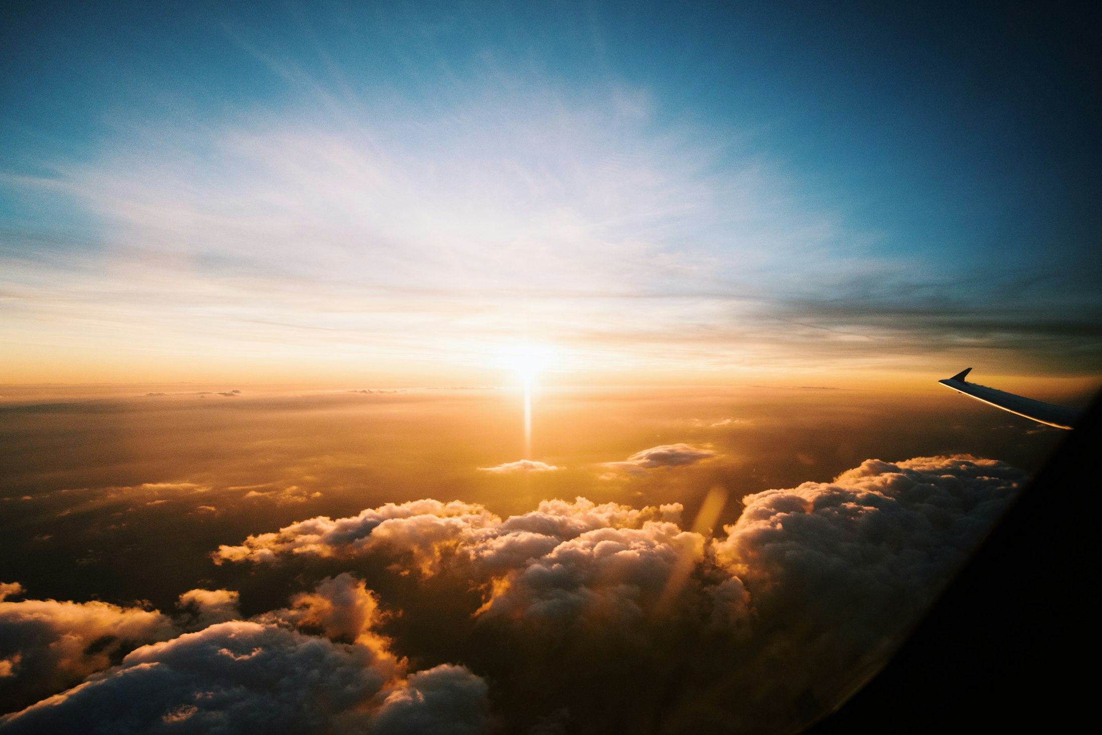 Sunrise above the clouds seen from the plane window